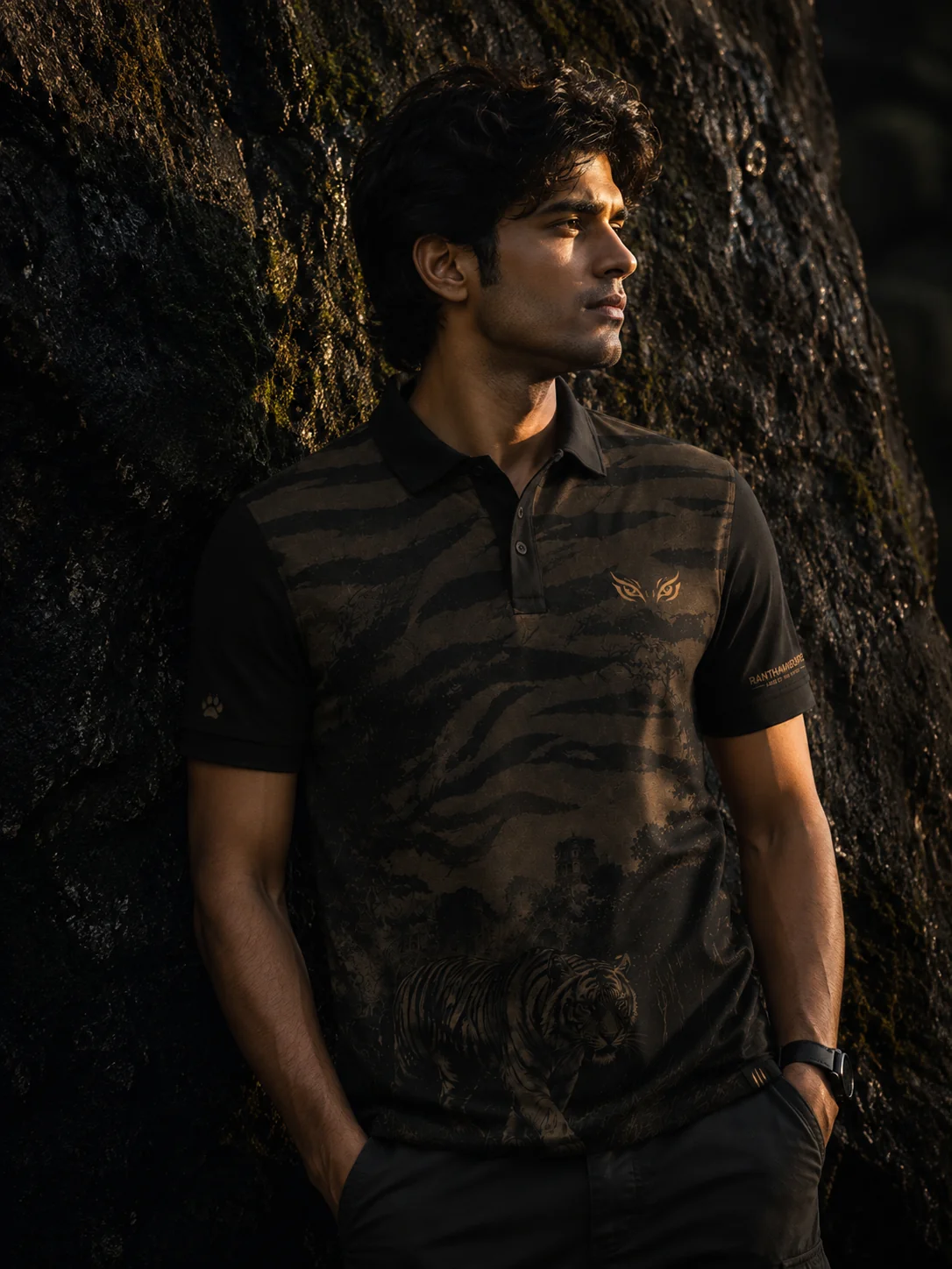 Ranthambore Inspired Polo T-Shirt — model wearing the polo against mossy rock, golden hour